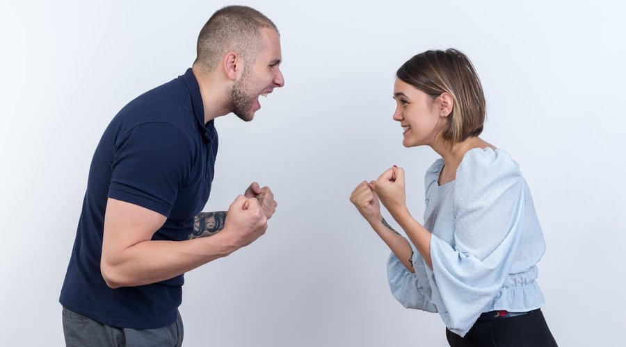 young-beautiful-couple-man-woman-quarreling-shouting-with-clenched-fists-standing-white-wall